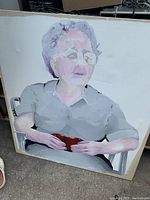 Painting of an elderly woman with gray hair seated holding a red object, abstract watercolor style