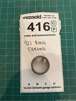 View of sterling silver ring on MaxSold lot card showing the ornate wave/leaf etched pattern