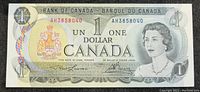 Front side of the 1973 Bank of Canada 1 dollar note showing Queen Elizabeth II and serial numbers.