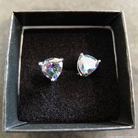 Top view of triangular mystic topaz type stud earrings in black display box.