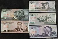 Front side of 5 specimen North Korean won banknotes in denominations 10, 50, 100, 500, and 5000 won.
