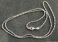Close-up of the sterling silver chain showing the link detail and lobster clasp