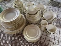 Overall view of full dish set arranged on lace tablecloth