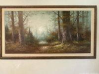 Front view of framed landscape painting hanging on wall