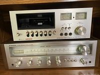 Front view showing Pioneer CT-F2121 deck stacked above SX-450 receiver with silver faceplates and wood side panels