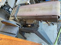 Side view of belt and disc sander on metal tripod stand