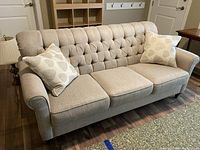 Full front right angle view of sofa with two pillows