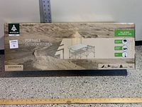 View of the Woods portable outdoor kitchen box with product image and brand logo.