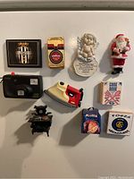 Overview of fridge magnets showing various themes including football, coffee, Christmas, cooking, and vintage appliances.
