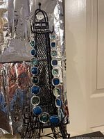 Photo showing the full length of the Anne Klein necklace draped over a wire Eiffel Tower stand.