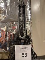Vintage Anne Klein necklace displayed on black mesh Eiffel Tower stand with MaxSold lot tag