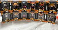 Front view of all 12 Aggretsuko figures in original packaging showing character artwork and branding.