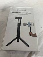 Photo of the front of the Lume Cube Mobile Creator Stand box showing the product image and branding.