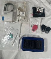 Overview of all 12 tech accessory items including watch band, phone cases, earbud case, earbud tips, key finders, and cord savers.
