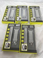 Five boxed Vivitar Adventure Awaits watch bands in dark color, for 42mm Apple Watch, shown in original retail packaging with yellow and black design.