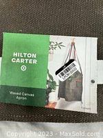 Photo of packaging label showing Hilton Carter branding and product identification as a waxed canvas apron.
