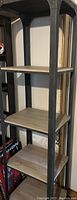 Full view of the 5 shelf narrow bookcase showing metal frame and wood-grain shelves.
