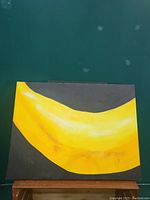 Front view of the banana oil painting showing full canvas with a large yellow banana on a black background.