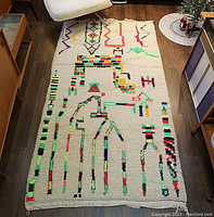 Full view of handwoven rug on hardwood floor with mid-century furniture