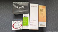 Photo showing all five skincare products in their original packaging arranged in a row.