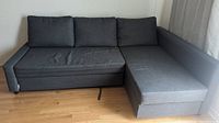 Ikea grey fabric sectional couch in L-shape layout with three back cushions and chaise on right side.