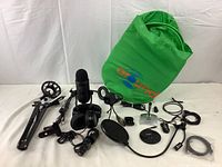 Overview of all items including microphone, headphones, cameras, stands, pop filters, green screen and cables