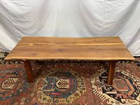 Front view of live edge oak coffee table on patterned rug