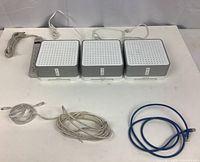 Three Sonos Connect:Amp units on table with power strip and assorted cables laid out
