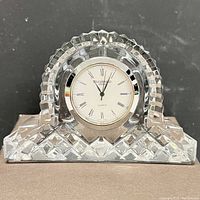 Front view of clear Waterford Crystal traveller's clock showing clock face with Roman numerals and Waterford branding.