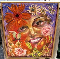 Front view of the framed oil painting showing a smiling woman's face surrounded by colorful flowers in orange, pink, yellow and purple hues.