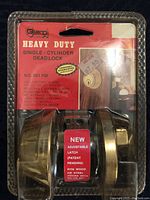 Clear image of the heavy duty single-cylinder deadlock in packaging, showing brand Guard, model 281 HD, gold color, adjustable latch, and installation instructions included.