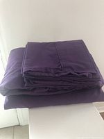 Photo of folded purple king-size sheet set showing color and fabric texture.