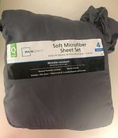 Photo of packaged soft microfiber queen size sheet set by Mainstays, dark grey color, four pieces with label showing details