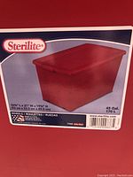 Label on packaging showing Sterilite brand, 45 gallon capacity, inches and cm measurements, and indication of wheels.