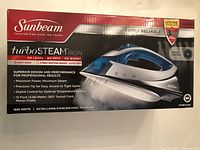 Sunbeam TurboSTEAM iron box front showing brand, model, 1500 watts, extra-large stainless steel soleplate, 3-way motion auto-off, and 12-foot swivel cord features