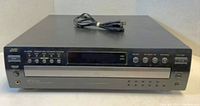 Front view of JVC XL-FZ258 CD player showing control buttons, display panel, and headphone jack with power cable on top.