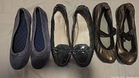 Three pairs of women's shoes placed side by side showing style and condition
