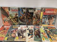 Front view of multiple Tarzan of the Apes comic books showing colorful illustrated covers, including Tarzan TV Adventures edition.