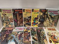 Photo showing 12 Brothers of the Spear comic books arranged in two rows, issues 7 through 18. Covers depict adventure scenes with various characters and animals in colorful vintage comic art style.