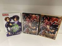 Three DVD cases of Code Geass anime series displayed side by side on a white background.