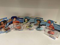 Five new Hot Wheels cars themed with Disney characters shown in packaging: Moana, Wreck-It Ralph, Mulan, Jasmine, and Patrick Star.