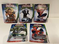 Lot of five Ultimate Spider-Man vs Sinister Six Hot Wheels cars in original sealed packaging, showing characters and car designs.