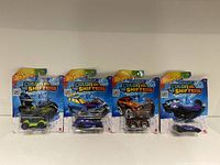 Four Hot Wheels Color Shifter cars in original packaging, showing front view of blister packs and cars.