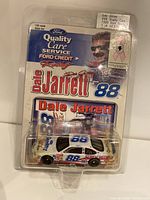 Front view of the sealed plastic blister pack showing the diecast car and packaging graphics with Dale Jarrett branding and Ford Credit logos