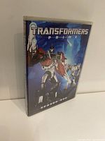 Front cover of the Transformers Prime DVD case featuring Optimus Prime and other characters in an action pose.