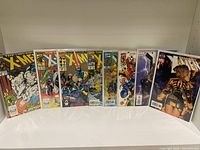 Front view of 9 vintage The Uncanny X-Men comics fanned out showing cover art and issue numbers