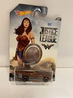 Front view of Wonder Woman Hot Wheels car sealed in original Justice League themed packaging featuring Wonder Woman art and logos.