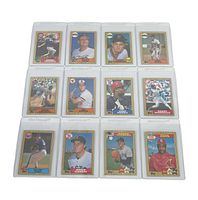 Full view of all 12 baseball cards arranged in 3 rows and 4 columns, each in individual clear protective sleeves.