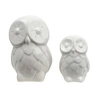 Front view of large and small white porcelain owl figurines showing detailed facial features and feathers.