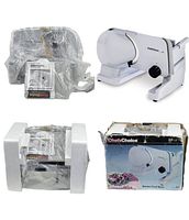 Electric food slicer with packaging showing the slicer unit, styrofoam inserts, instruction manual, and original box with damage.